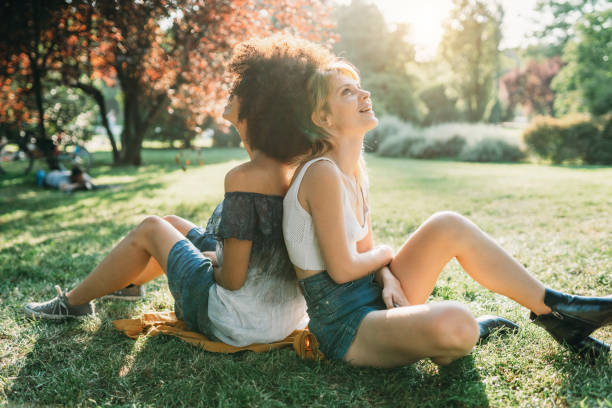 istock Two friends together at the park 1383836698