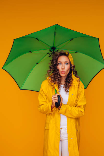 istock Girl with green umbrella 1383837847