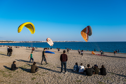 Konyaaltı beach/Antalya-11/21/2021 .Crowd learning to paraglide, view of konyaaltı coast and beydağları in the afternoon