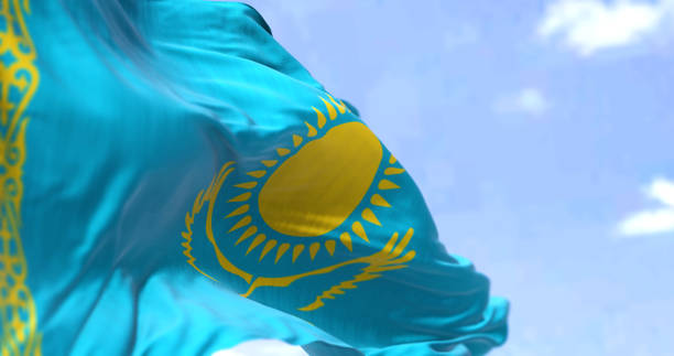 Detail of the national flag of Kazakhstan waving in the wind on a clear day. stock photo