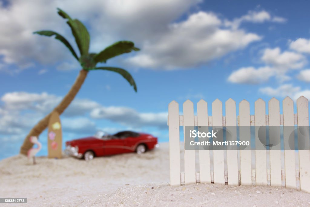 Fence on Tropical Beach with Vintage Hot Rod in Background Fence on Tropical Beach with Vintage Hot Rod in Background and Blue Sky Spring Break Stock Photo