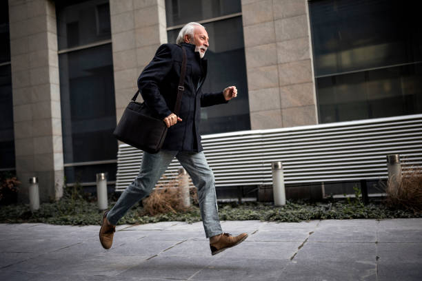 istock Mature Businessman Rushing to the Work Running 1383844217