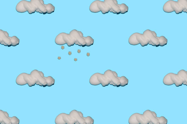 foam clouds smeared all over the background pastel blue colors from a cloud falling snowflakes of white flower creative concept