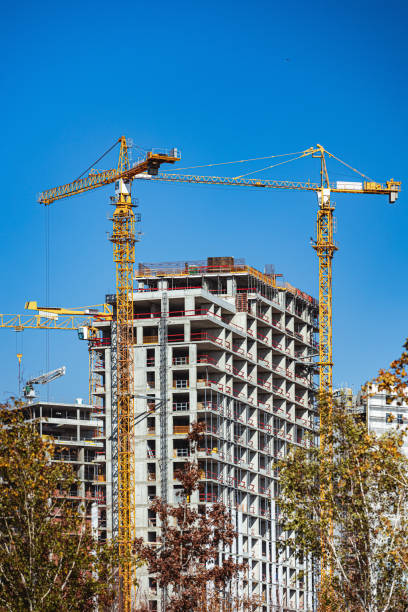 istock Cranes on construction site in the city, residential area development 1383844587