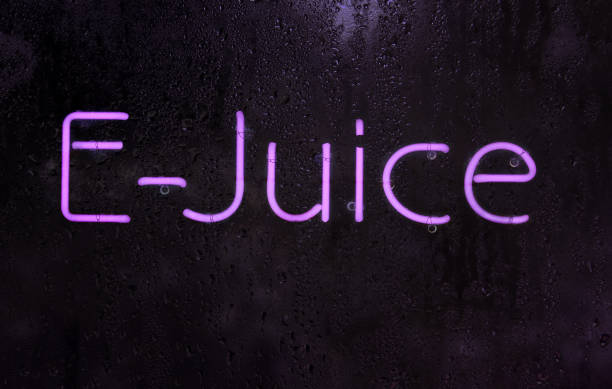 Purple Neon E-Juice Sign in Rainy Window stock photo