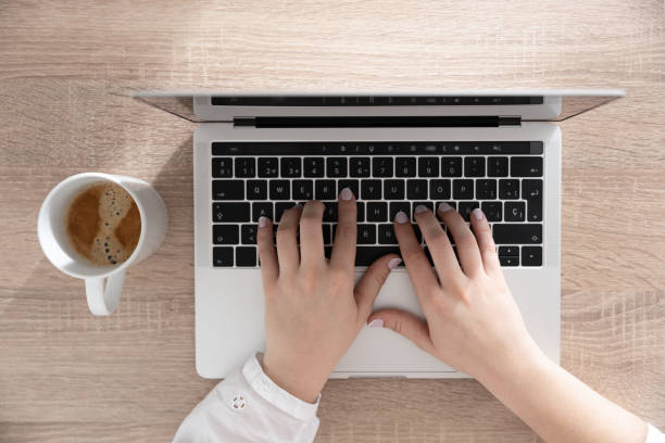istock View from above of hands typing on laptop 1383847616