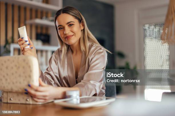 Portrait Of A Smiling Girl Holding One Makeup Product Stock Photo - Download Image Now