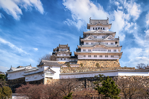 Himeji, Japan - March 26, 2019: Himeji Castle during spring cherry blossom season. The castle dates from 1333 and is considered one of the finest surviving example of Japanese castle architecture.