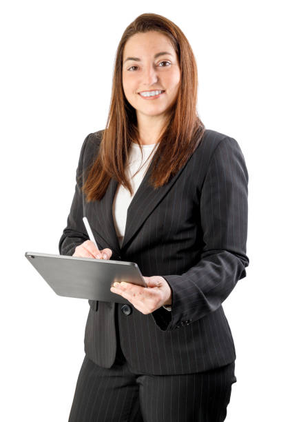 Business woman holding a tablet, wearing a suit, smiling looking at camera. with Isolated on white background. 40-45 years old woman.