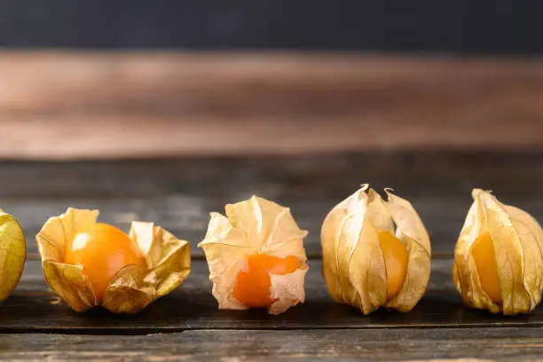 Cape gooseberry or golden berry (Physalis peruviana) on wooden background, Healthy tropical fruit