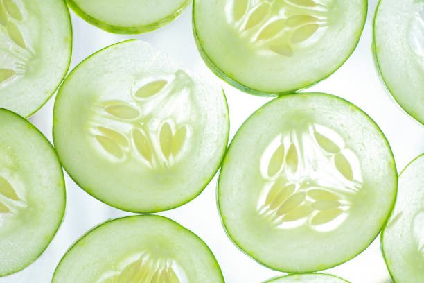istock fresh cucumber slices background. fruit and vegetable pattern backgrounds 1383854994