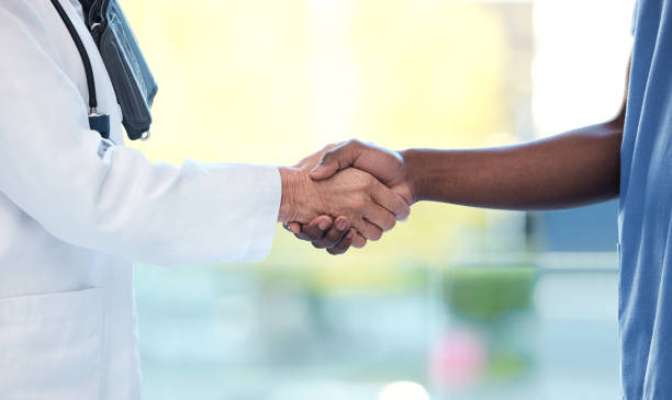 istock Shot of two unrecognizable doctors shaking hands at work 1383855423