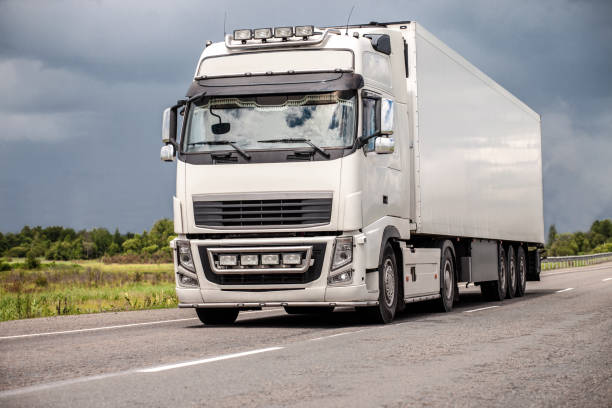 istock Blue truck on a road in summer 1383856650