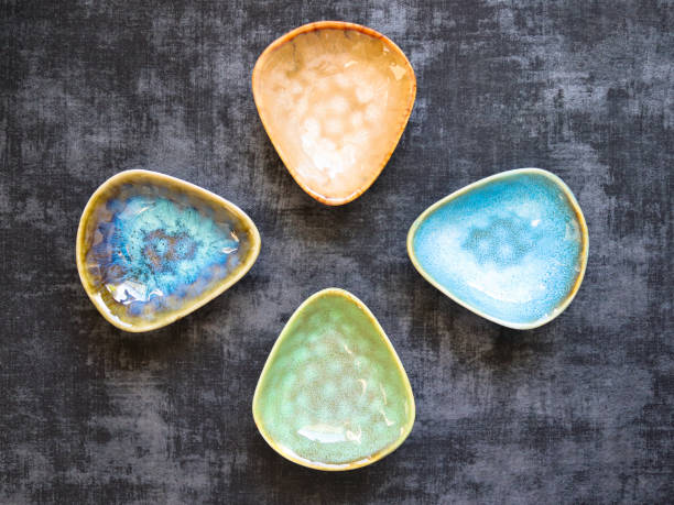 istock Four ceramic saucers in different colors on dark background 1383856941