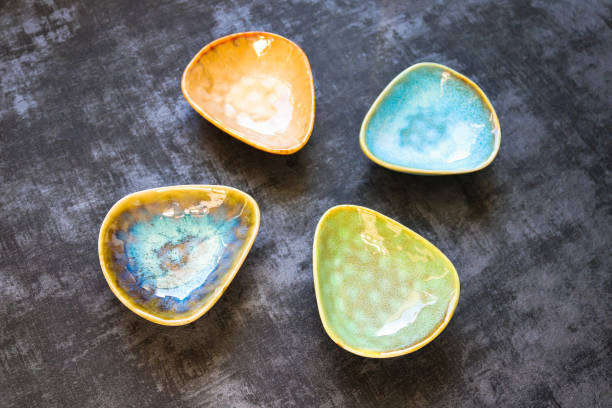 istock Four ceramic saucers in different colors on dark background 1383856947