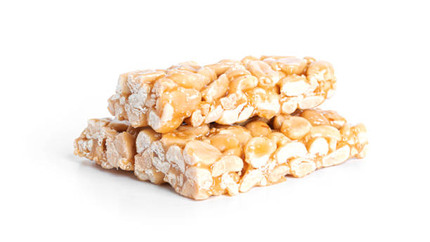 istock Peanut brittle isolated on white background. Peanuts in caramel. Natural candy bar 1383858520