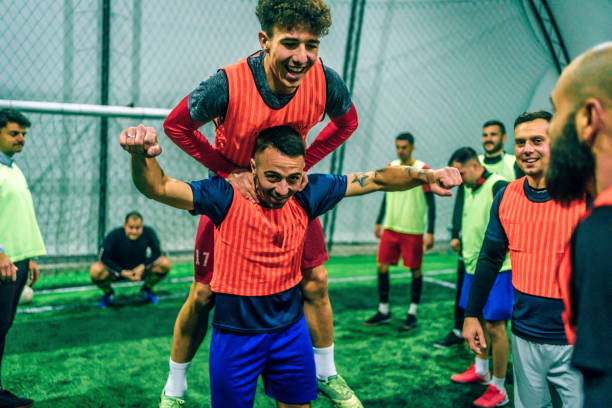 istock Soccer players cheering after winning match 1383858567