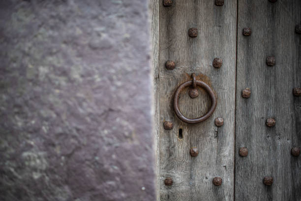 istock Old Wrought Iron Door Pull Handle on an old wooden door 1383858933
