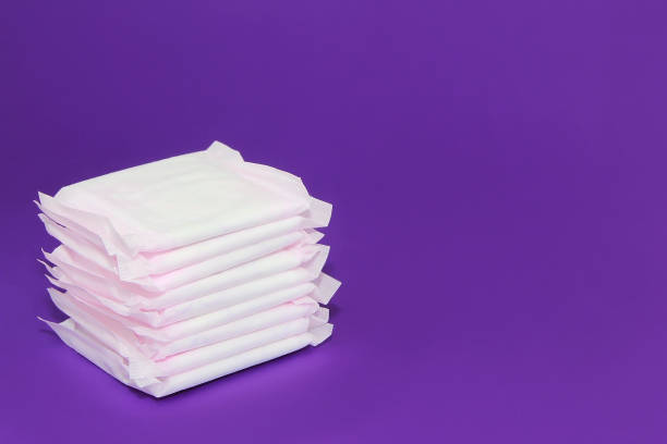 women's white sanitary pads for menstruation on a purple background very peri women's white sanitary pads for menstruation on  purple background very peri sanitary napkin stock pictures, royalty-free photos & images