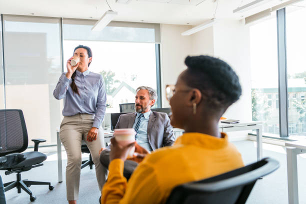 istock Group of business people on break in office. 1383859351