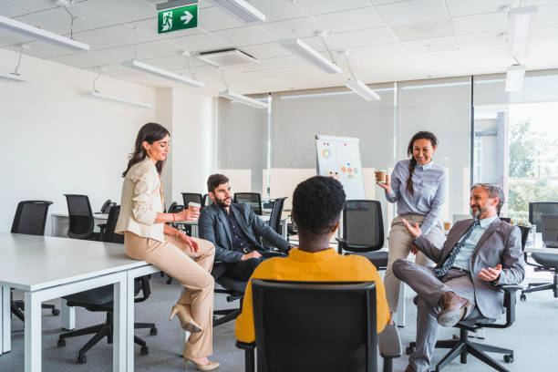 istock Group of business people on break in office. 1383859371