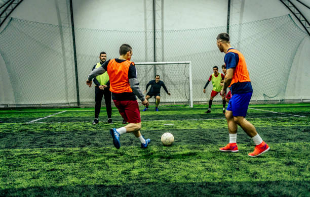 istock Soccer player kicking ball at goal 1383860236