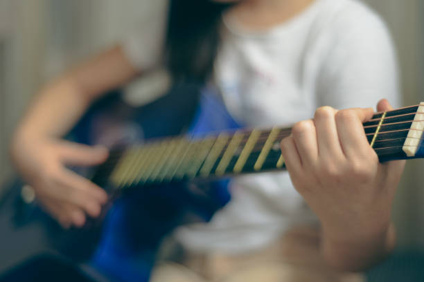 istock Girl learning to play guitar 1383860403