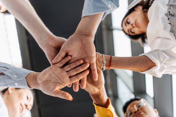 istock View from below. Successful business people putting their hands together. 1383860523