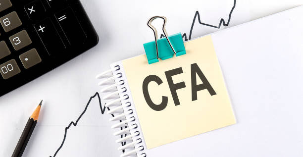 istock Stickers with pencils and notebook with text CFA on chart background 1383862918