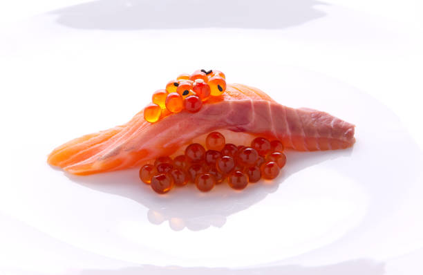 Overflowing sushi, salmon on a white plate Japanese food stock photo