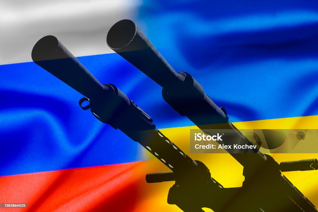 Military conflict between Russia and Ukraine, A gun against the background of two state flags of the warring states. Ukraine Stock Photo