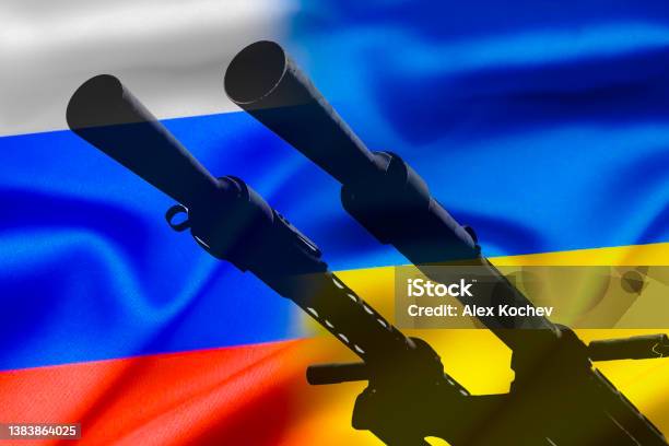 Military Conflict Between Russia And Ukraine A Gun Against The Background Of Two State Flags Of The Warring States Stock Photo - Download Image Now