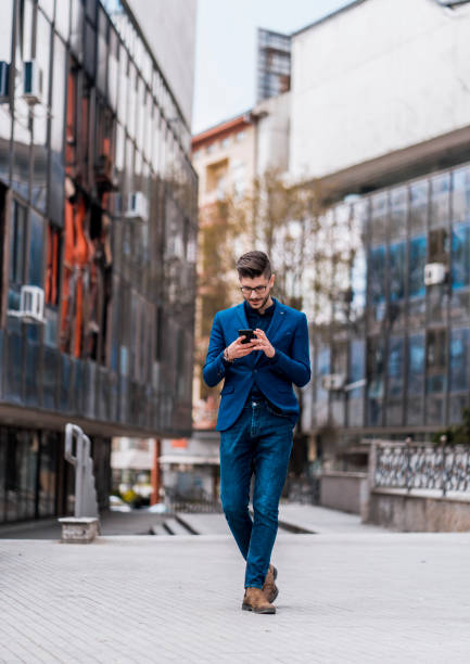istock Stylish businessman watching in his smartphone 1383867978