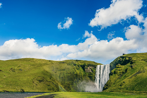 Skogafoss waterfall in Iceland on a summer's day with toning.