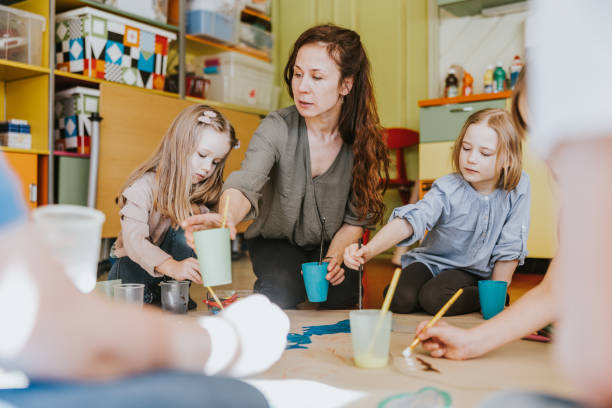 istock Group of children drawing at classroom 1383869035