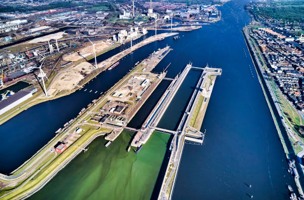 Netherlands Netherlands, IJmuiden - 20-02-2022: Aerial view of the largest sluice (lock) in the world. For the largest boats and ships a new sea lock in the Noordzeekanaal. sluice photos stock pictures, royalty-free photos & images