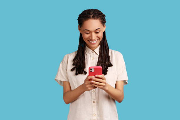 istock Woman sends text messages via mobile phone, uses smartphone app, browses webpage. 1383874468