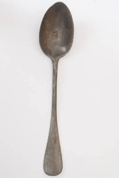 Old spoon on a white background