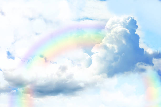 istock Fantasy world. Beautiful rainbow in sky with fluffy clouds 1383879281