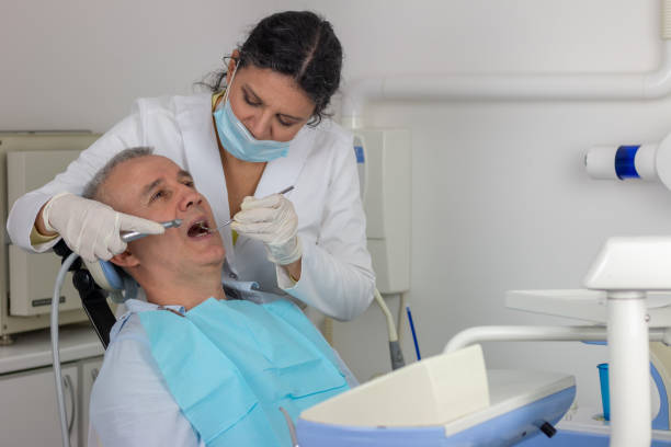 istock Open mouth during drilling treatment at the dentist 1383881014