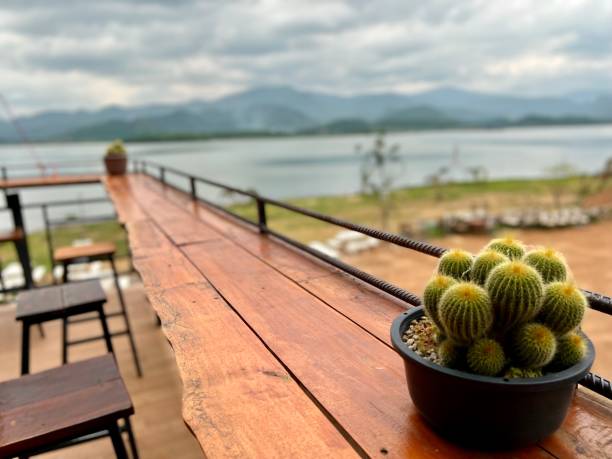 Wooden bar with water and mountain scenery stock photo