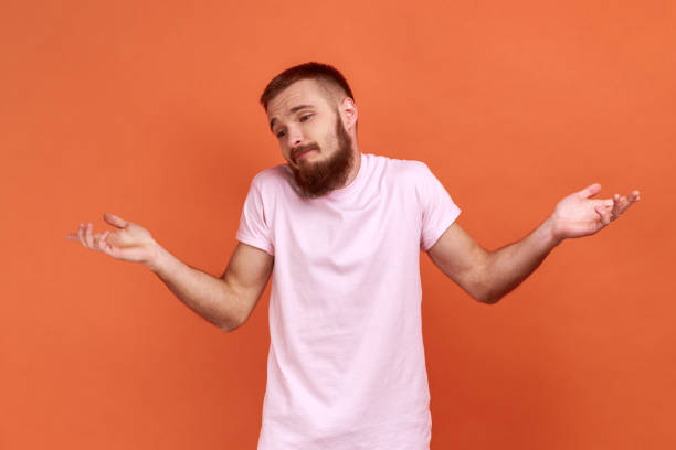 istock Don't know, who cares. Man standing with no idea gesture, shrugging shoulders raising hands. 1383882080