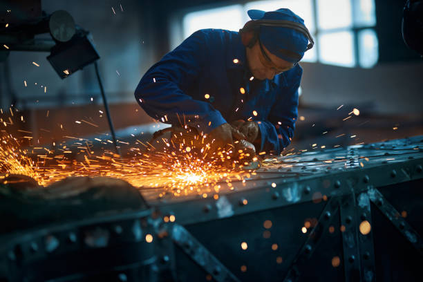 istock Worker polishing new modern fence with sparks. 1383883562