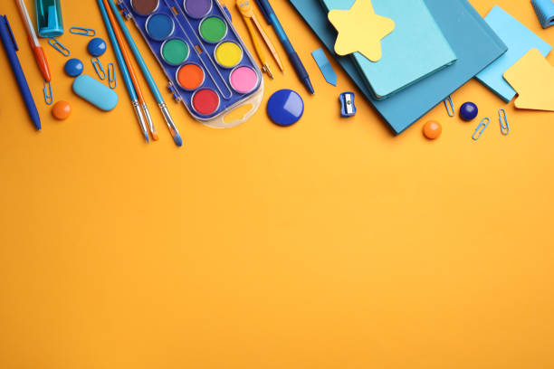 istock Different stationery on orange background, flat lay. Space for text 1383883850
