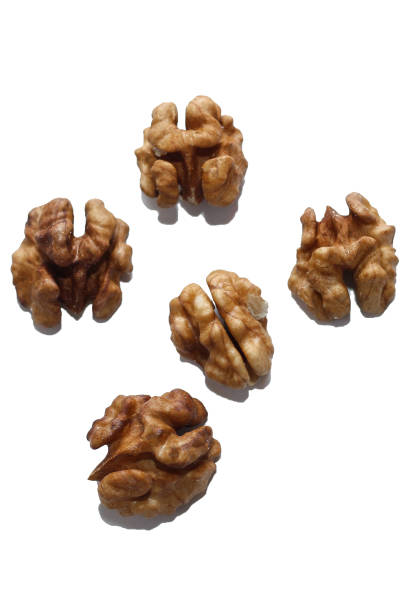 istock Walnut grains scattered isolated on white background 1383884948