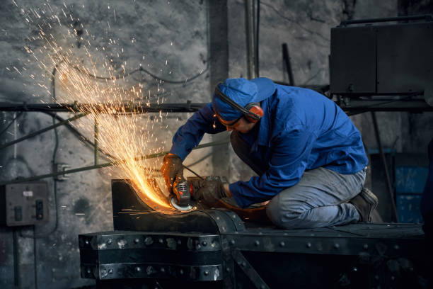 istock Young man working with electric machine for welding metal. 1383885264