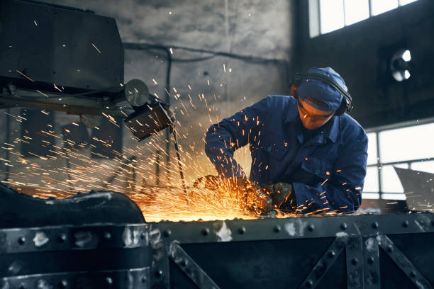 Fitter working with special machine for welding metal. stock photo