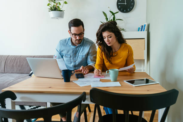 istock Serious Couple Paying Bills at Home 1383886923