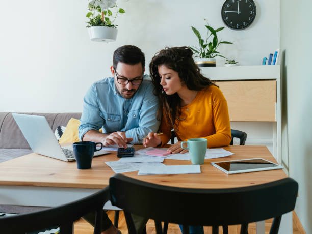 istock Serious Couple Paying Bills at Home 1383886924