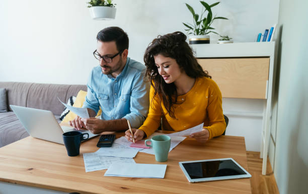 istock Happy Married Couple Paying Bills at Home 1383886928